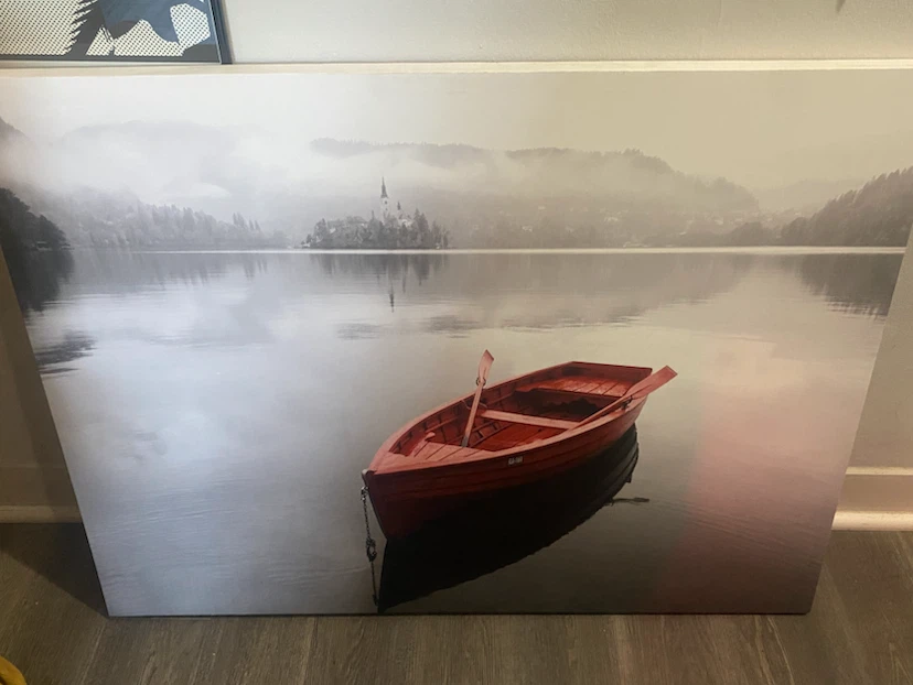 Canvas Print of Red Boat on Lake with Island Church