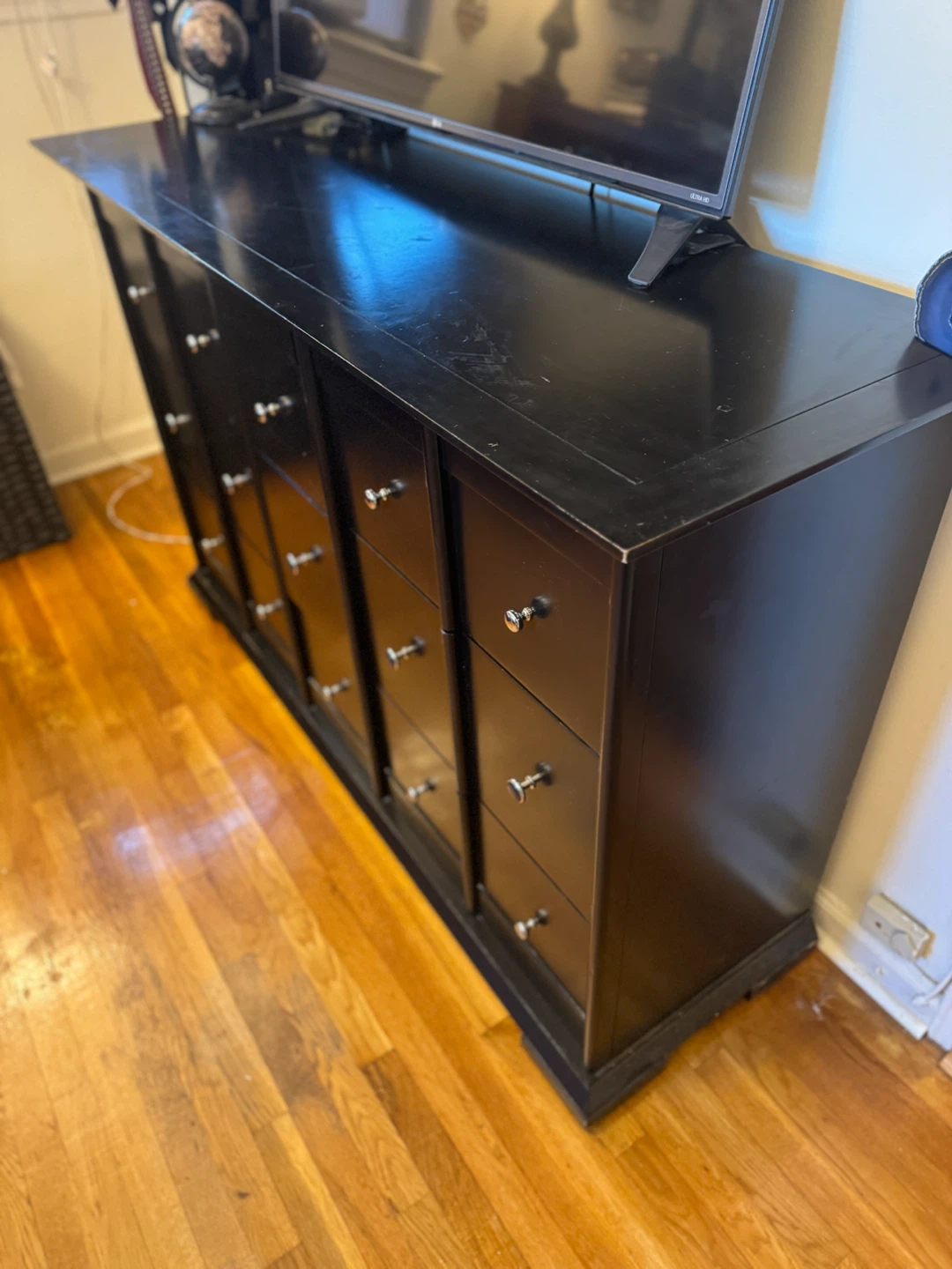 Black dresser with multiple draws and space