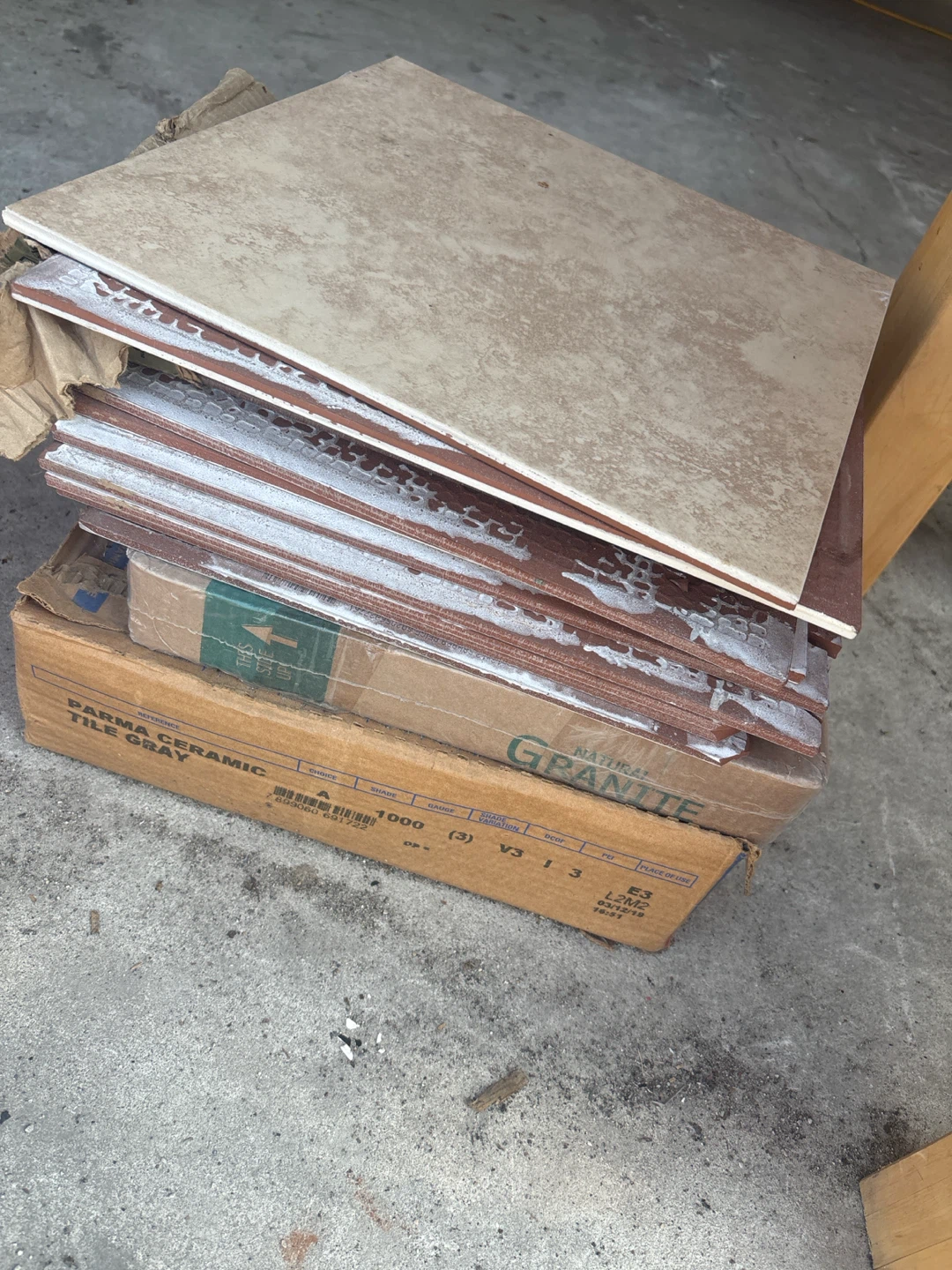 Grey tiles . Brown tiles and 5 piece black granite