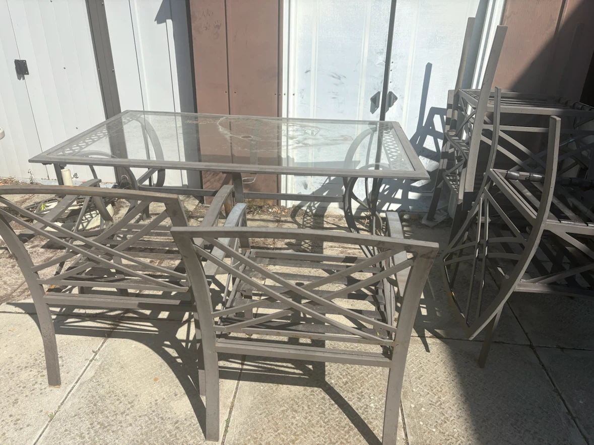 Metal patio dining set with glass top