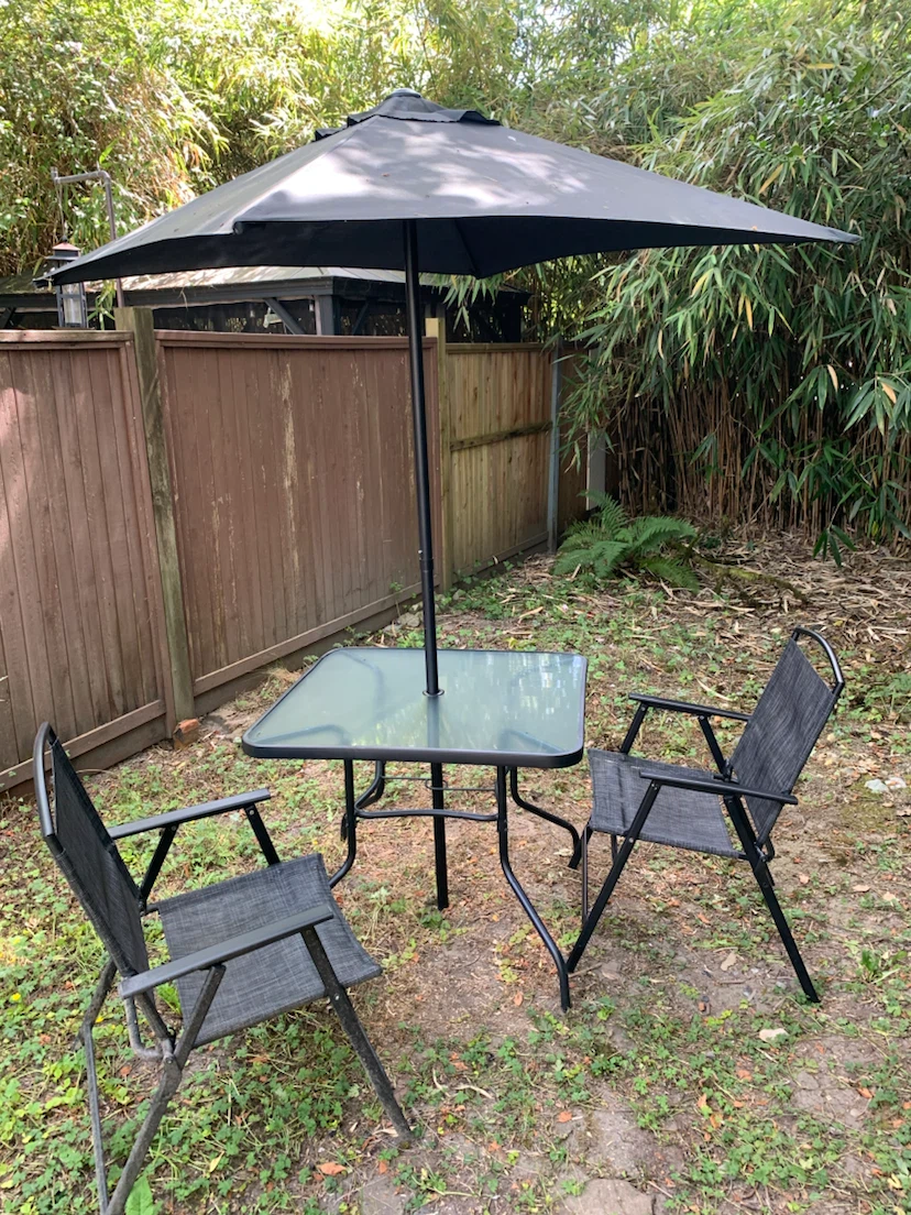Patio table and umbrella with two chairs