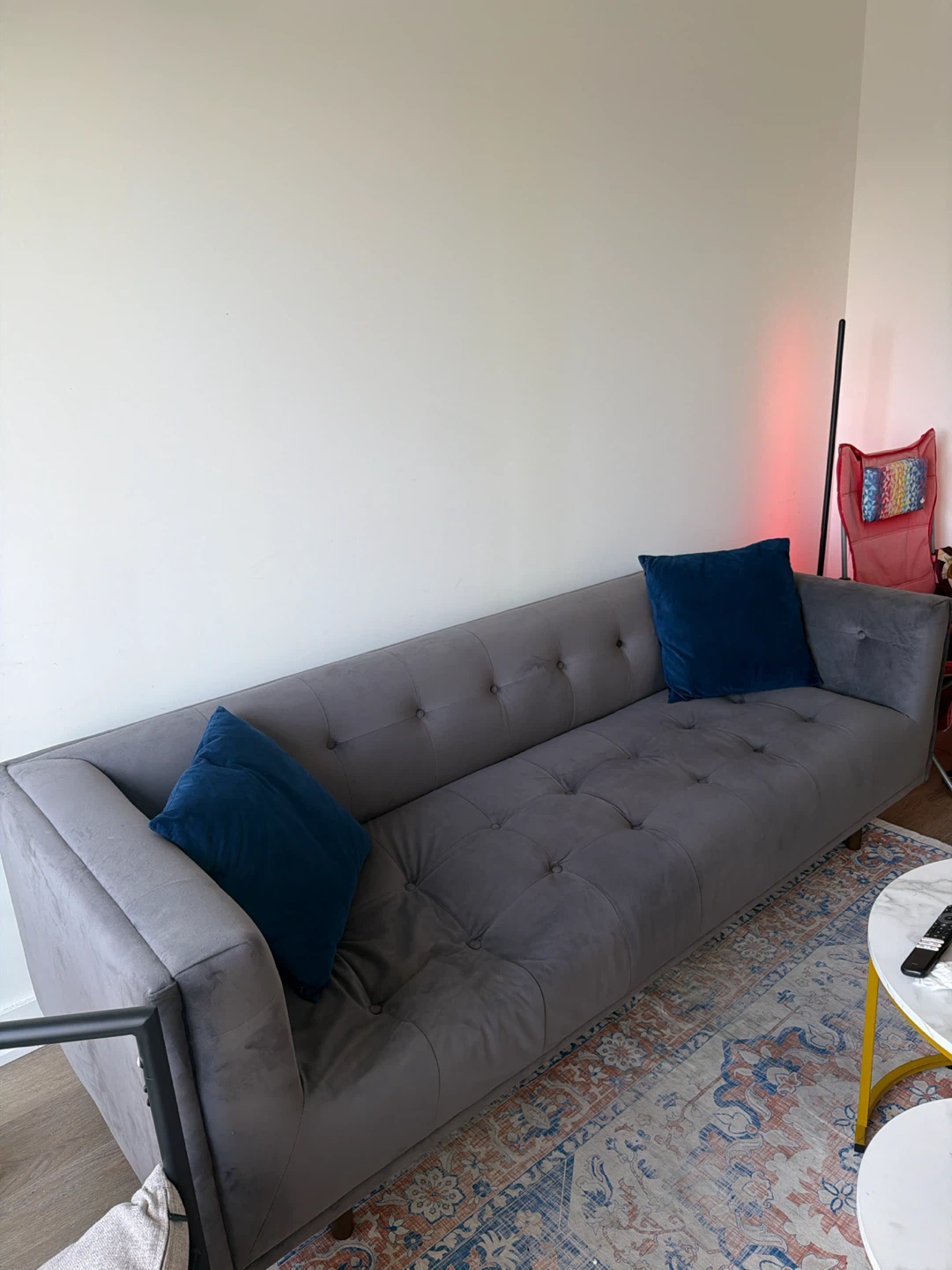 Grey Tufted Sofa with Blue Pillows