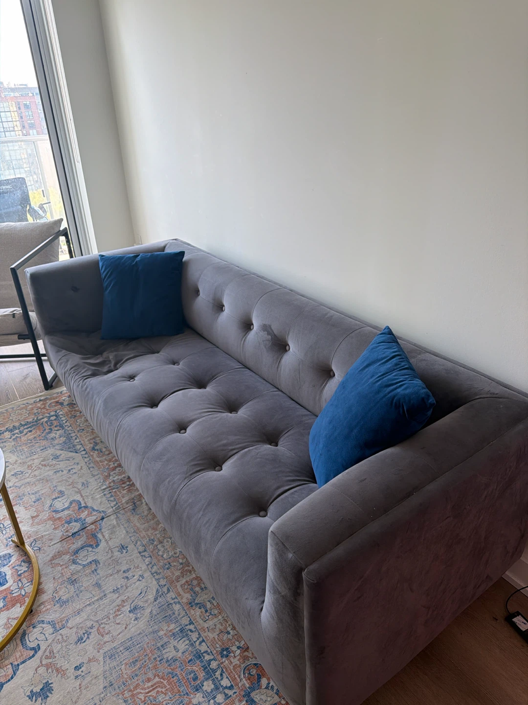 Grey Tufted Sofa with Blue Pillows - photo 2
