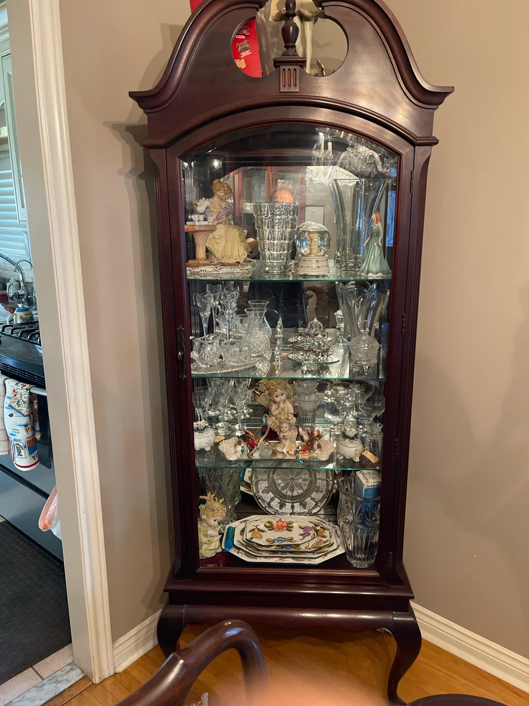 Wooden curio cabinet with glass doors