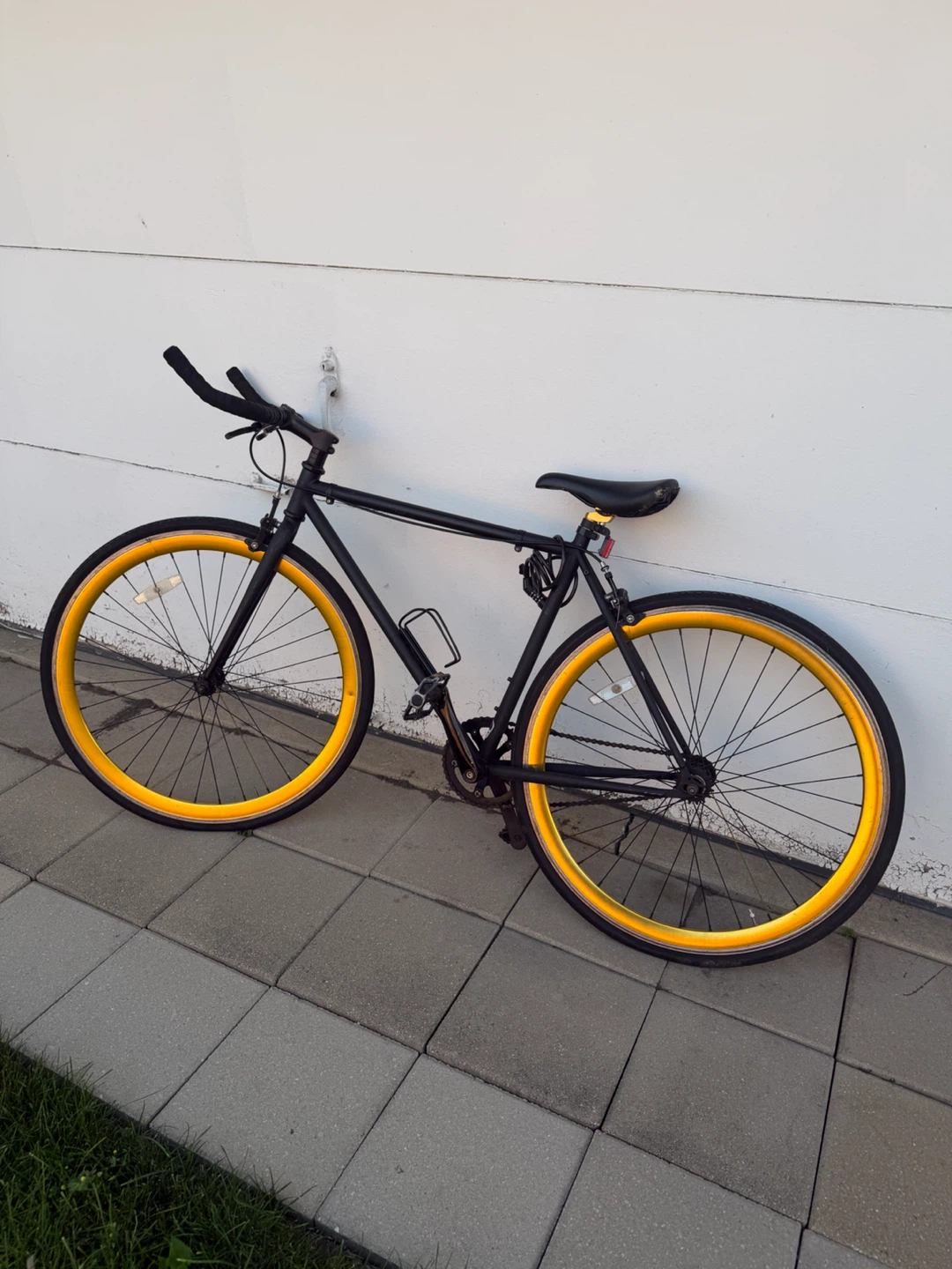 Black Single-Speed Bike with Yellow Rims