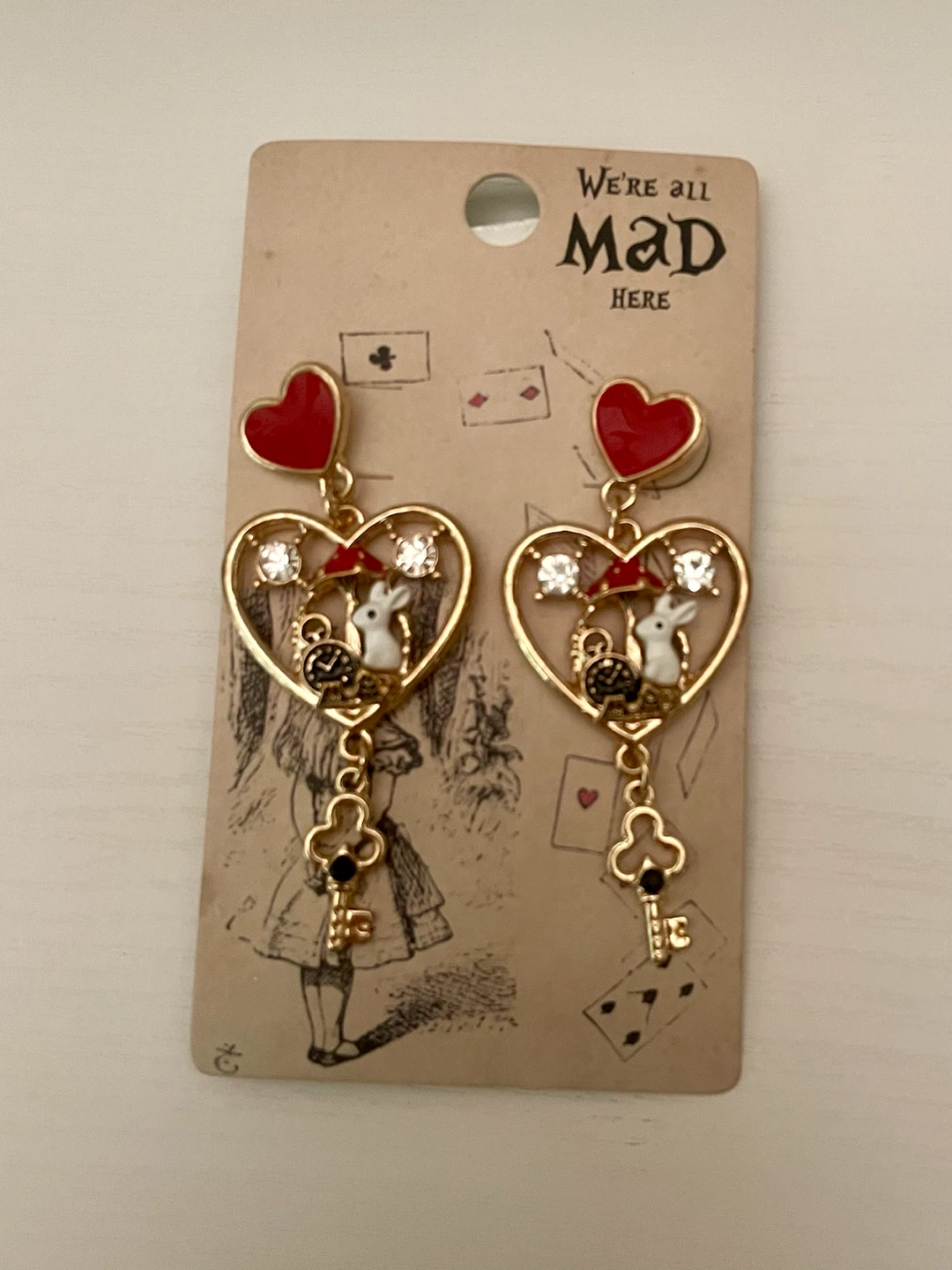 “We’re All Mad Here” Earrings — New in Package — $5