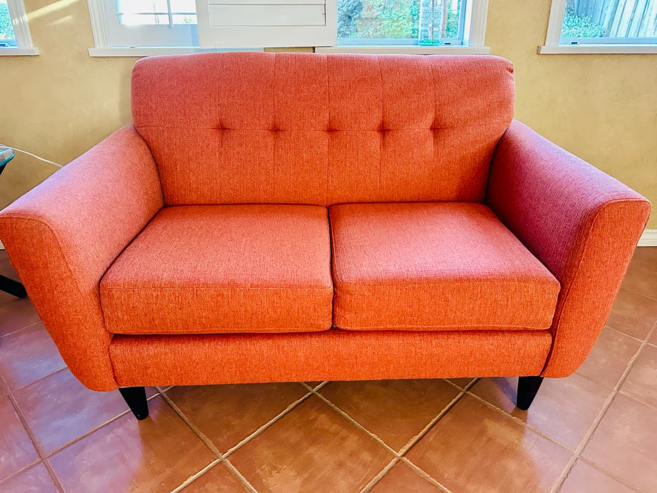 Orange 2-seater Sofa with H patterned Blanket