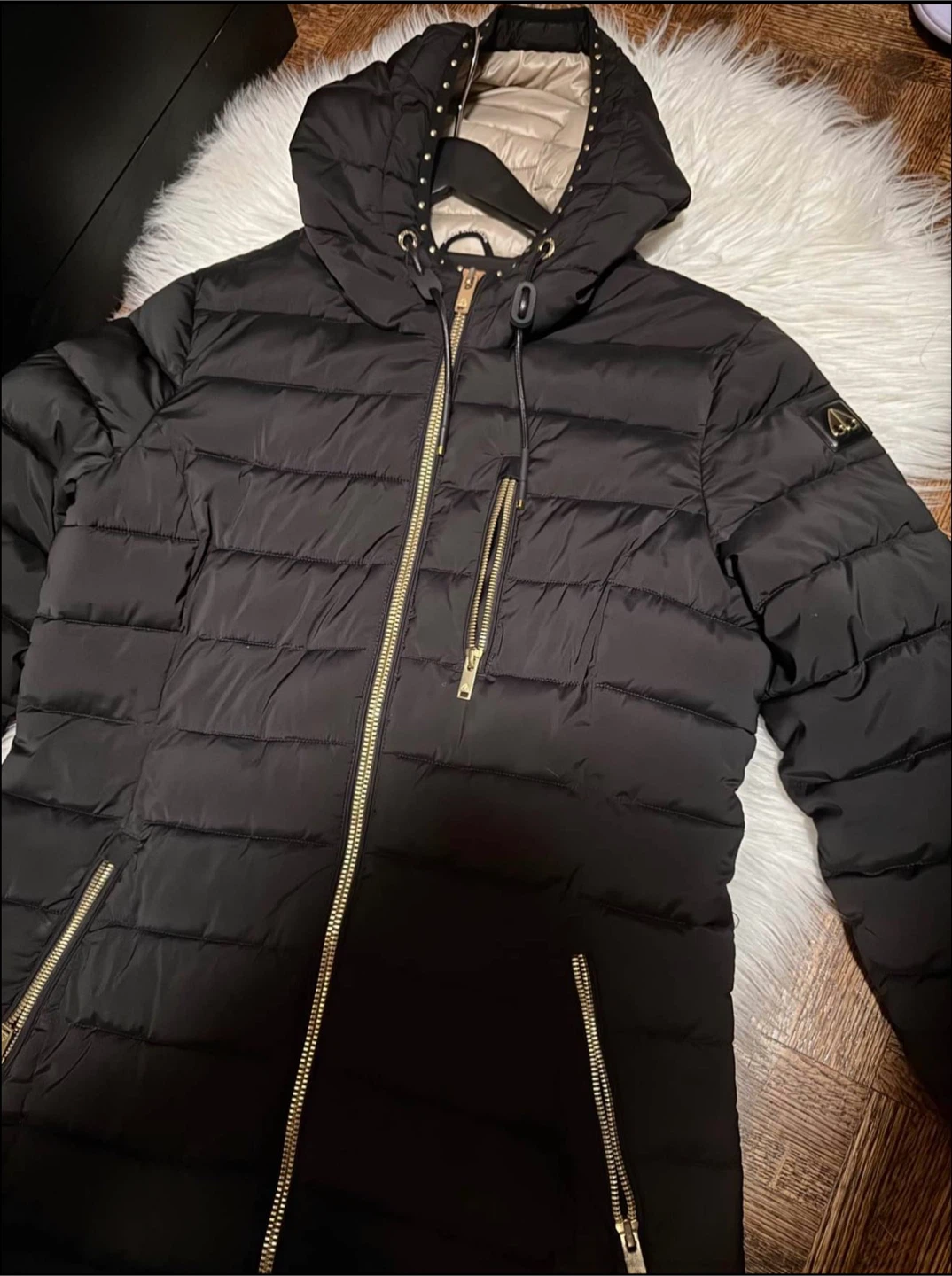 Moose Knuckles Black Puffer Jacket with Gold Accents