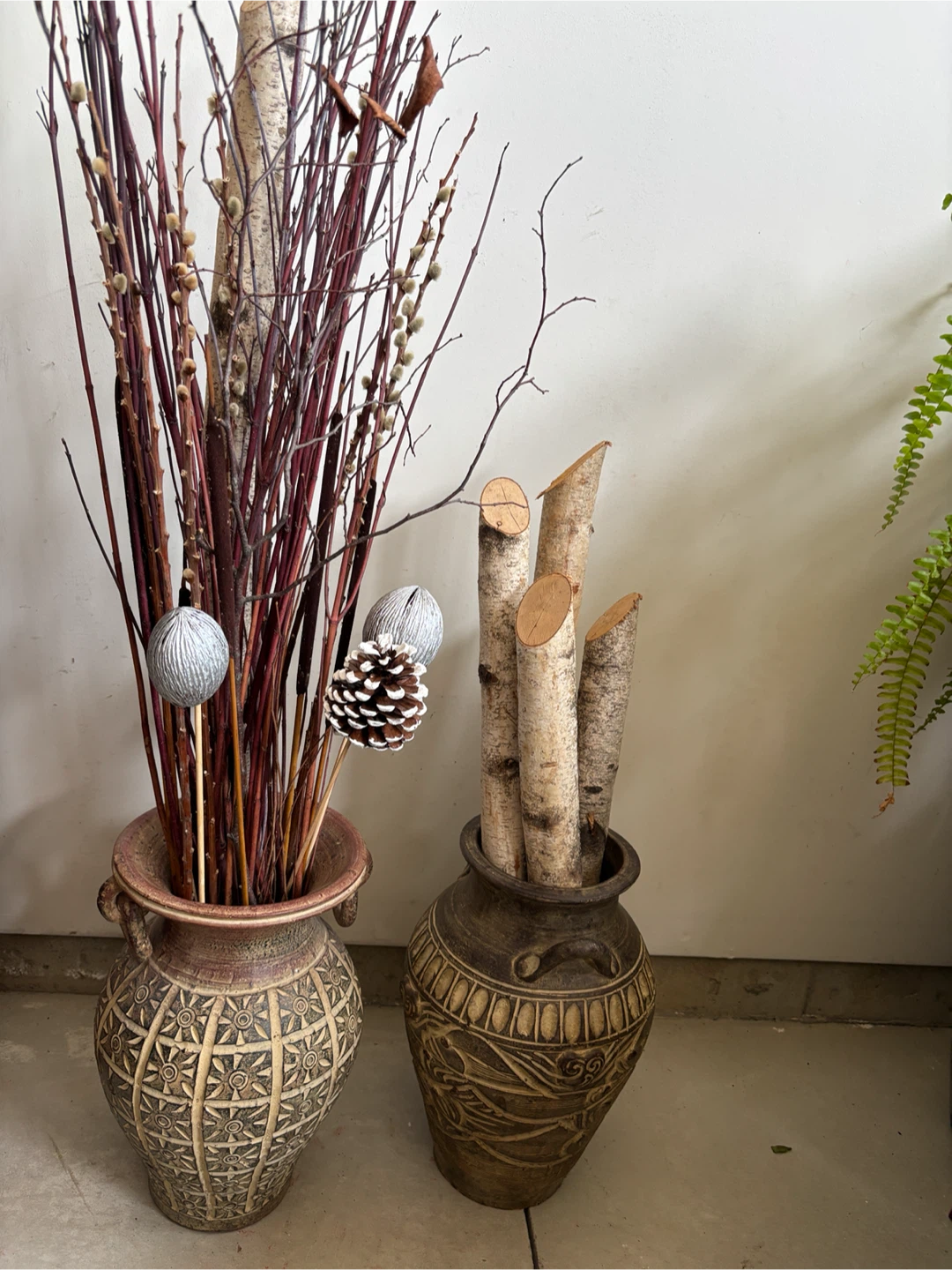 Decorative dried branches and birch logs in vases