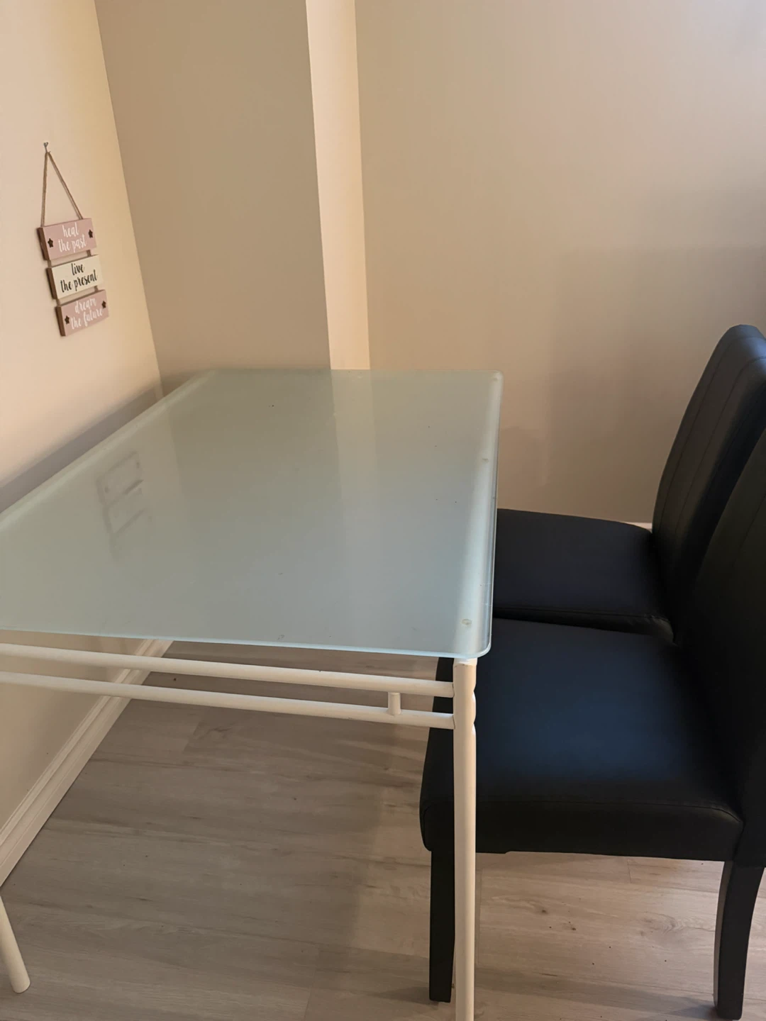 Glass Top Dining Table with two black chairs