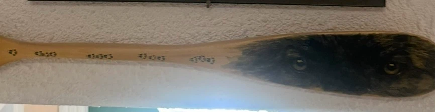 Hand-painted wooden paddle with animal design