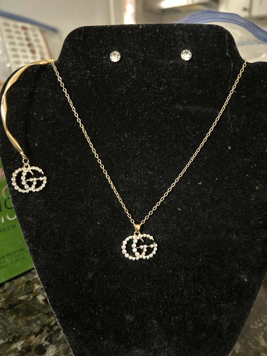 Gold tone necklace, set with sparkly 'GG' logo charms