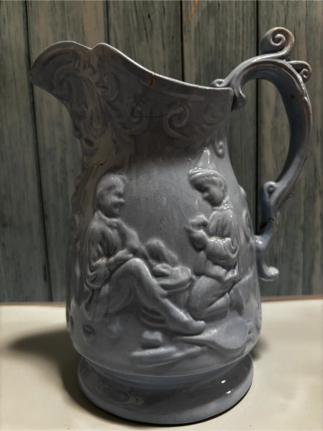 Vintage Blue Ceramic Pitcher with Embossed Figures
