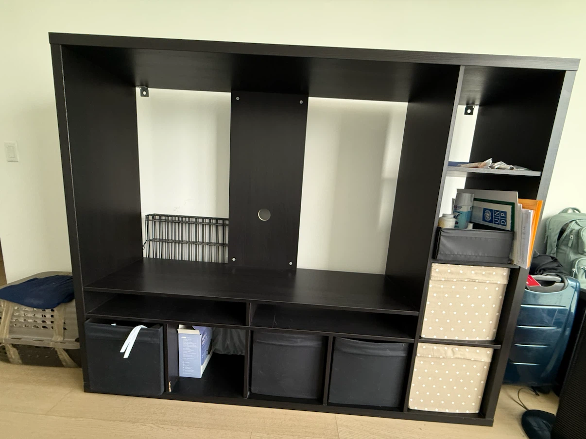 IKEA tv storage unit with 8 open shelves and shelf for TV