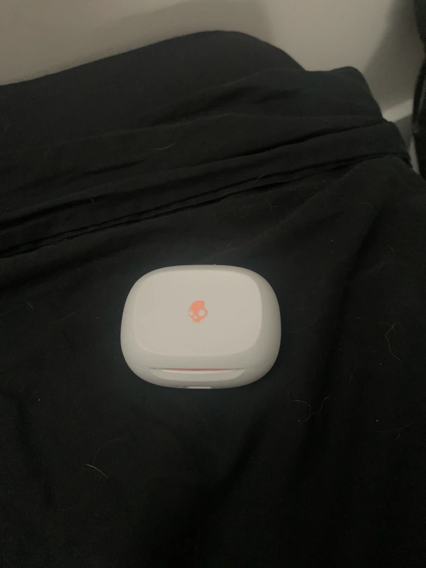 Skullcandy Smokin wireless earbuds in the Bone / Orange Glow