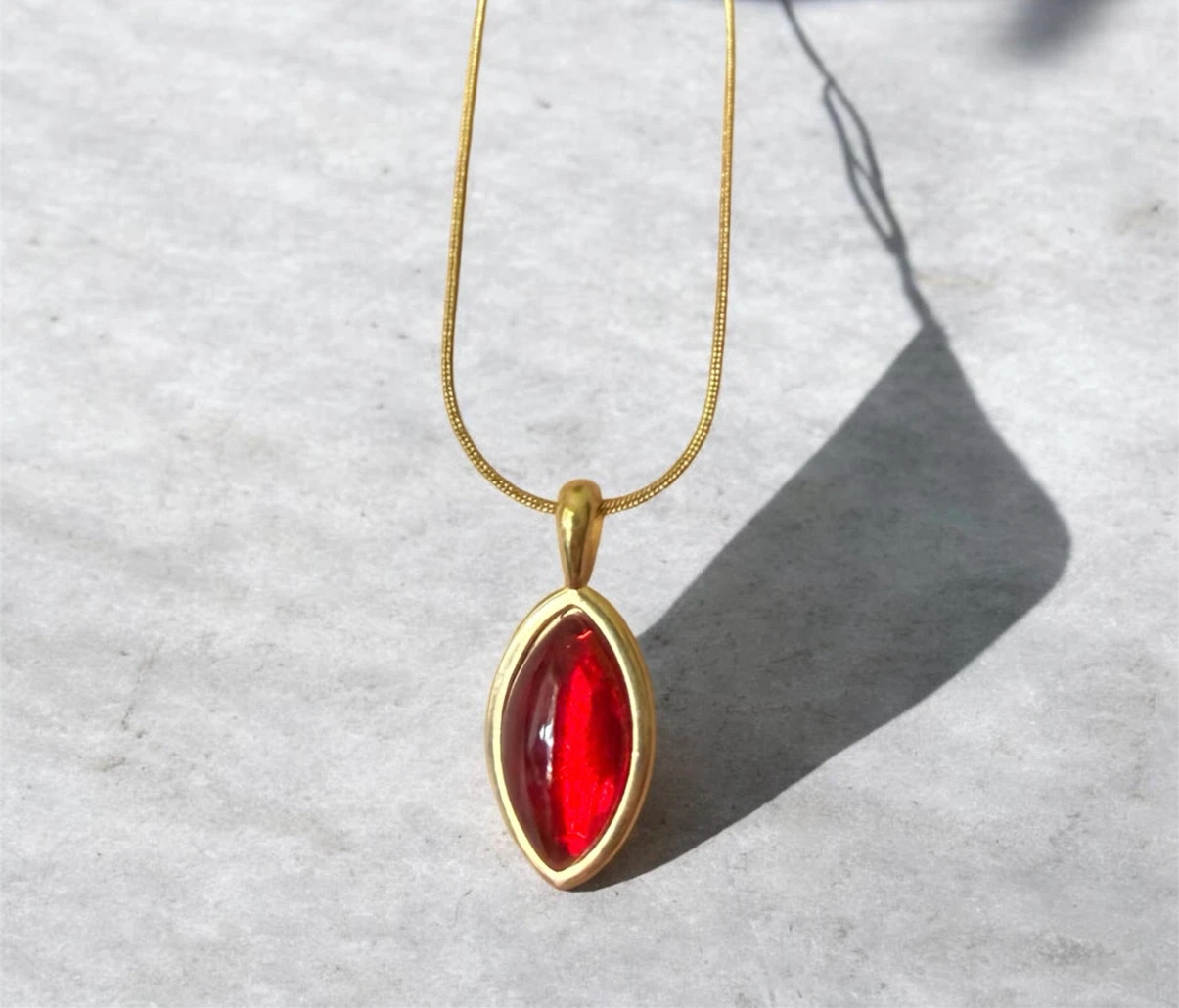Gold-tone necklace with red pendant