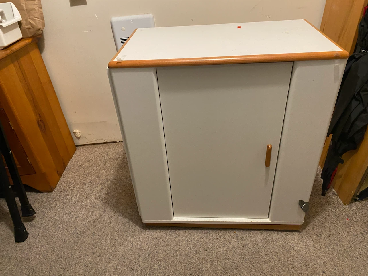 White storage cabinet with wood trim