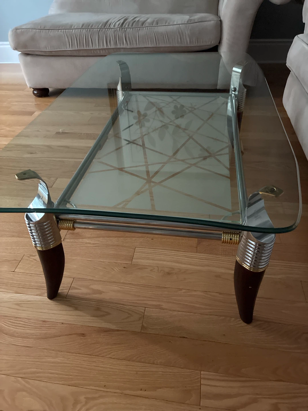 Glass top coffee table with chrome and wood legs