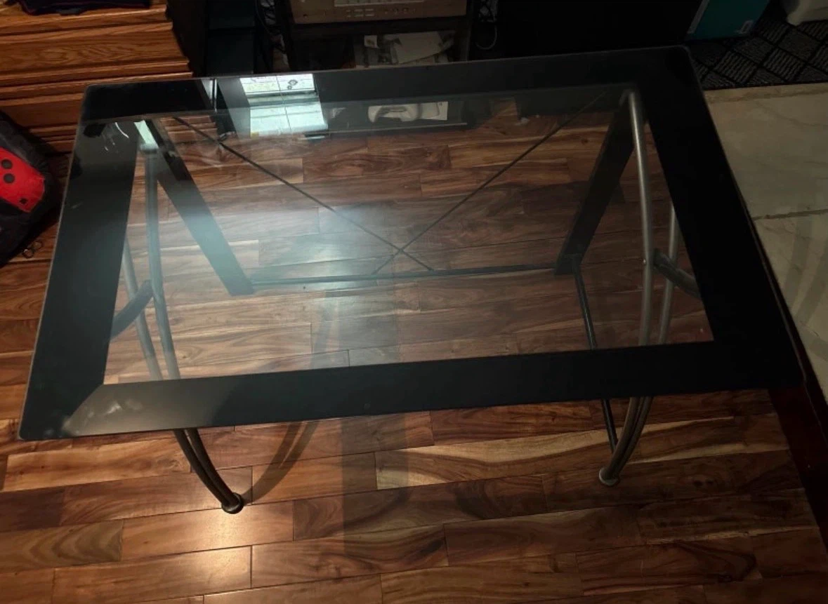Glass top coffee table with black frame