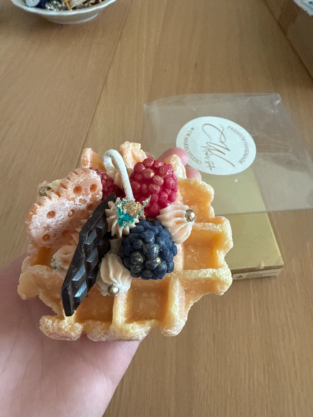 Waffle-shaped candle with berries and chocolate