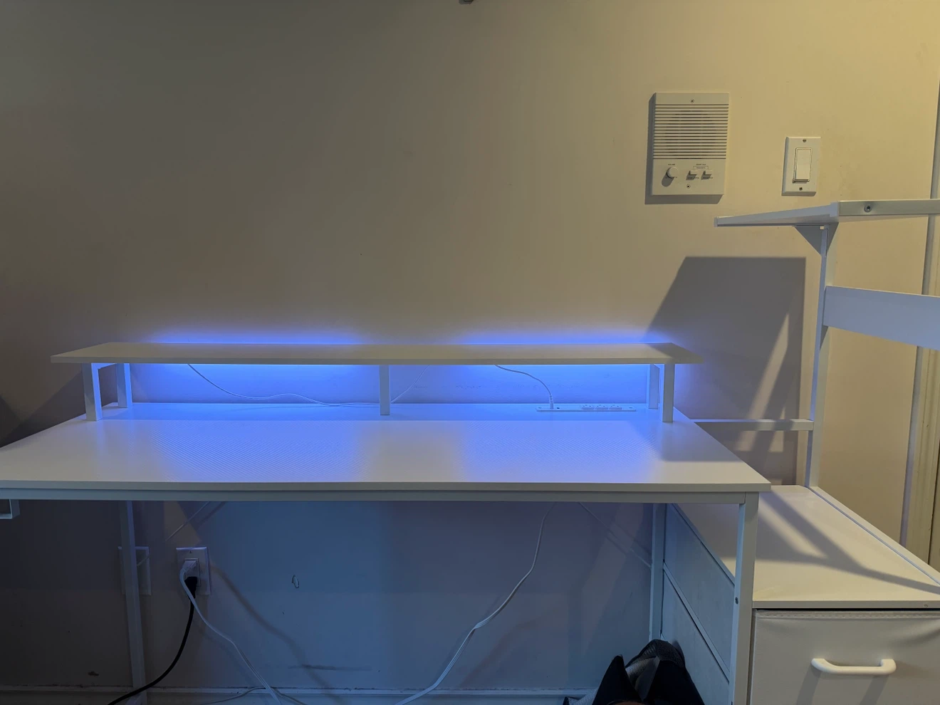 White computer desk with integrated power strip and LED lighting