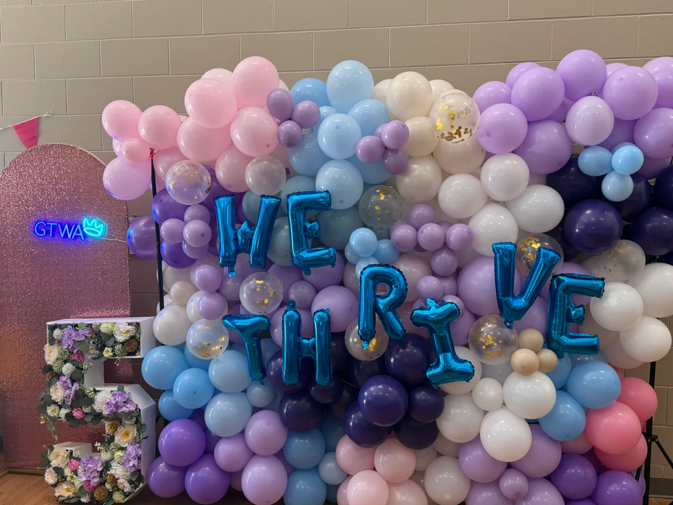 WE THRIVE Balloon Arch and Decor