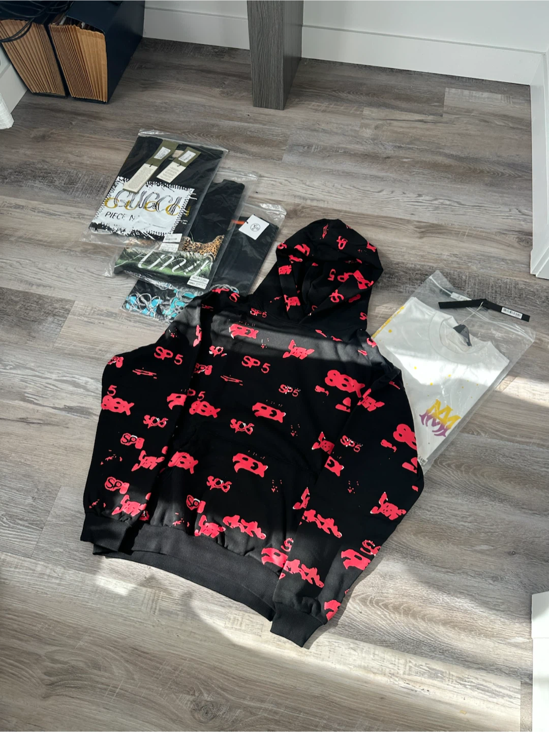 Black SP5 hoodie with red graphic print