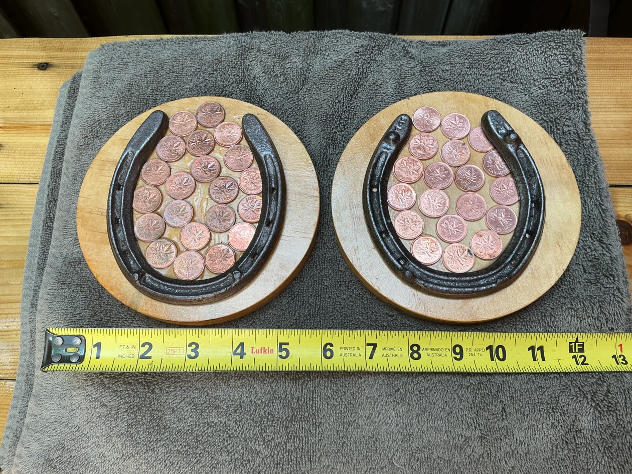 2 Antique Lucky Horseshoes with Canadian pennies on wood plaque