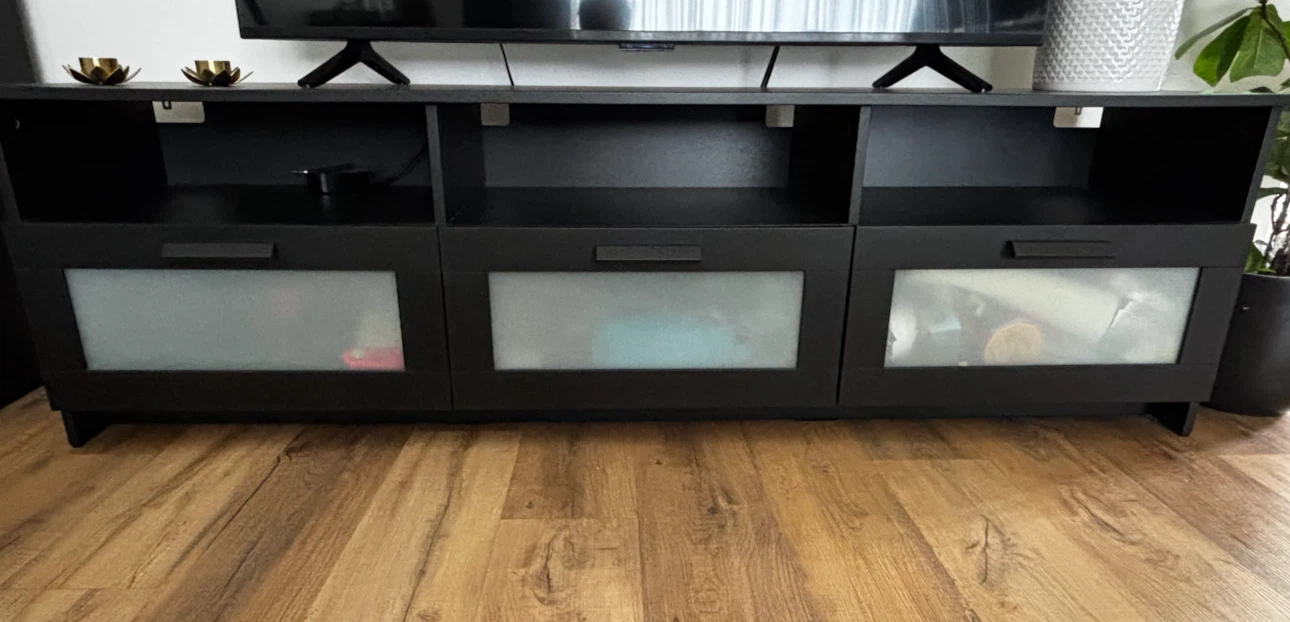 Black media console with frosted glass doors