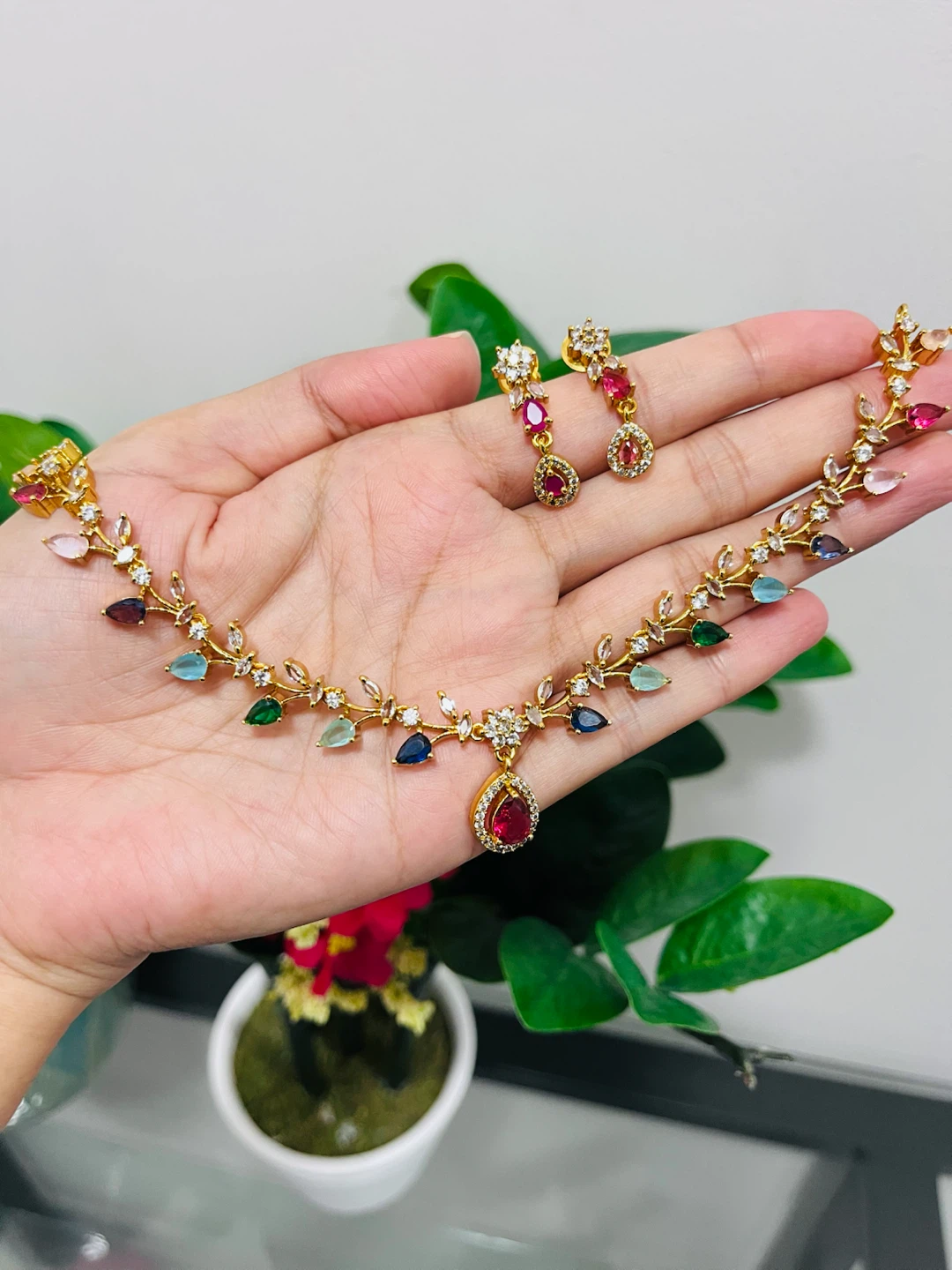 Gold-tone necklace and earrings set with multi-coloured stones