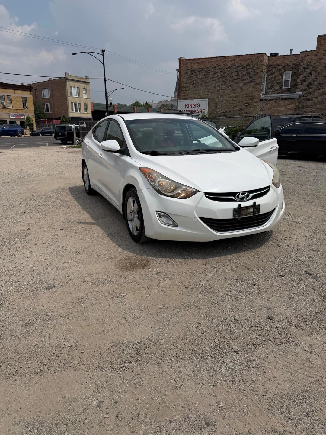White Hyundai Elantra with Red and Black Seat Covers