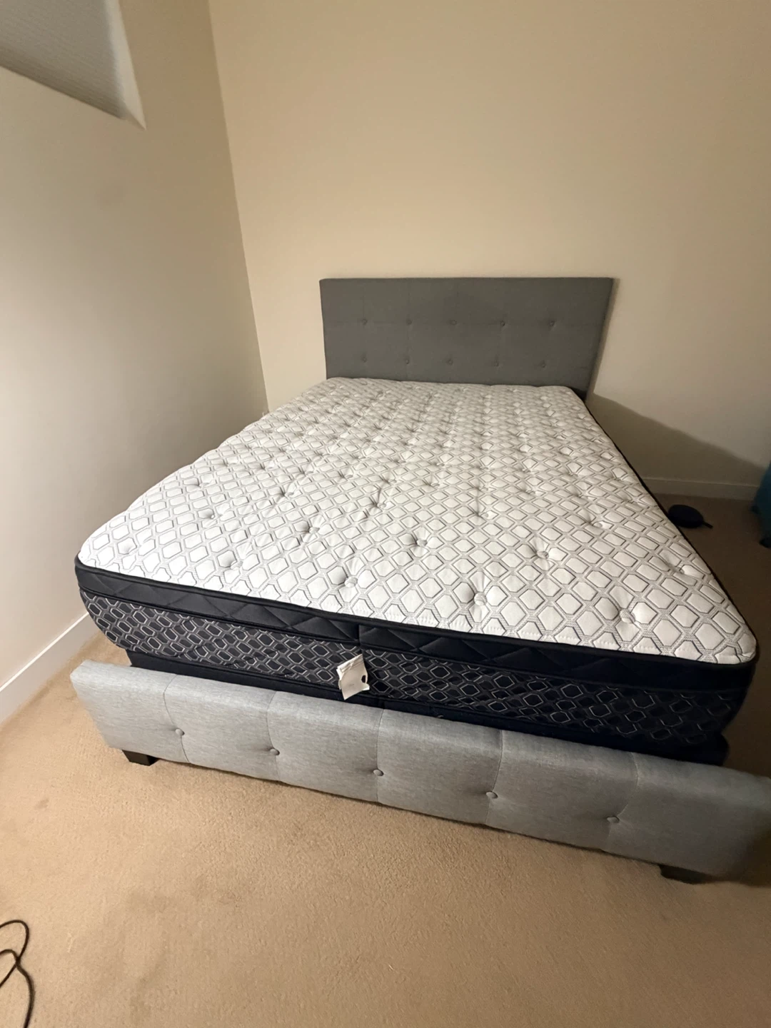 Queen bed with mattress and box spring.