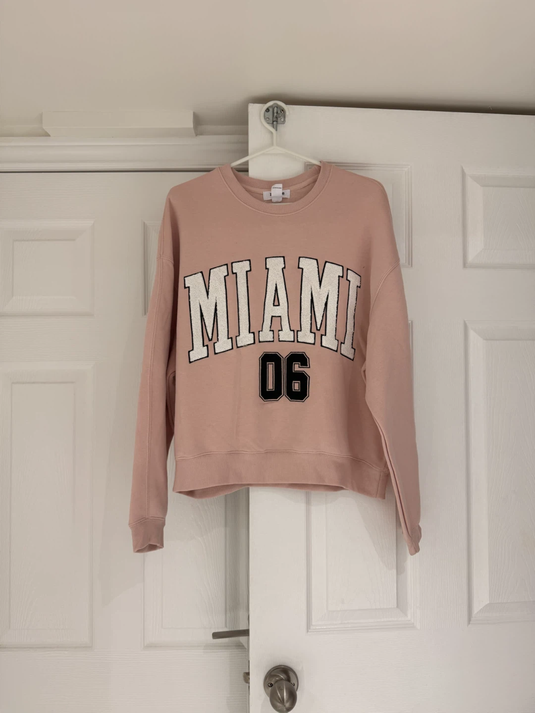 pink crewneck with “Miami”