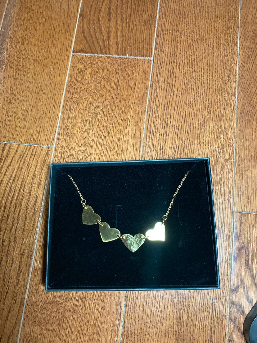 Gold tone necklace with heart pendants