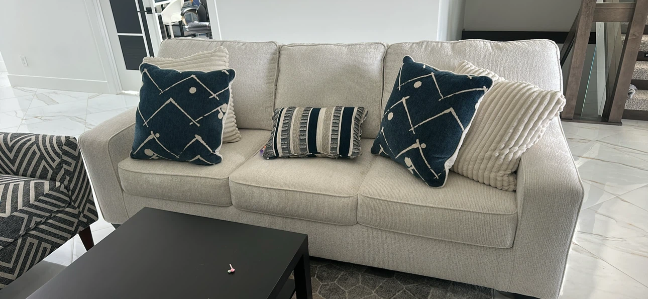 Cream coloured sofa with decorative pillows