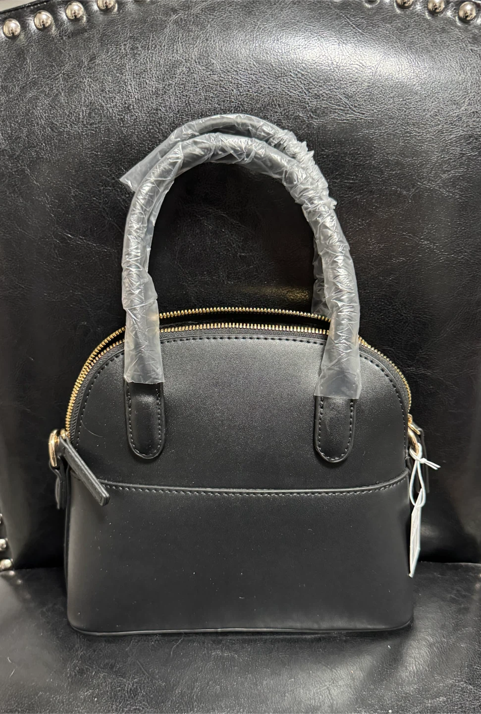 Black dome handbag with gold accents