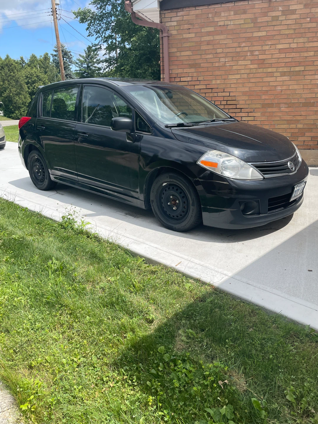 Black Nissan Versa SL Hatchback