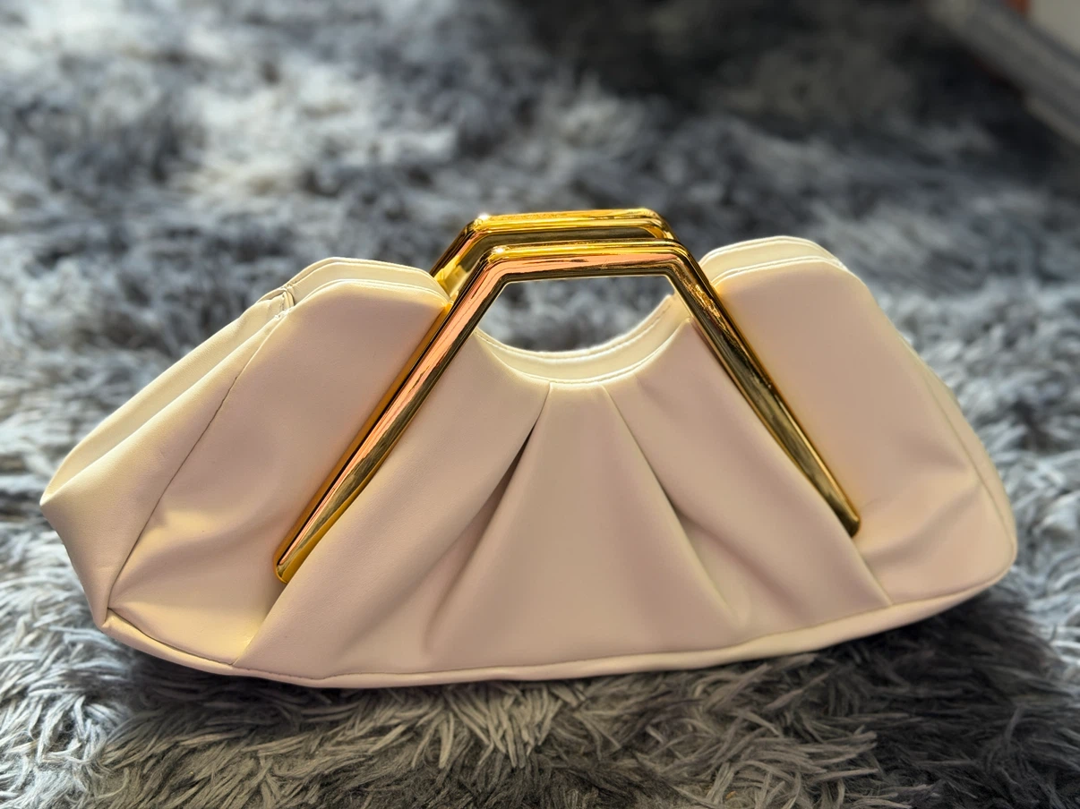 White clutch with gold frame handle