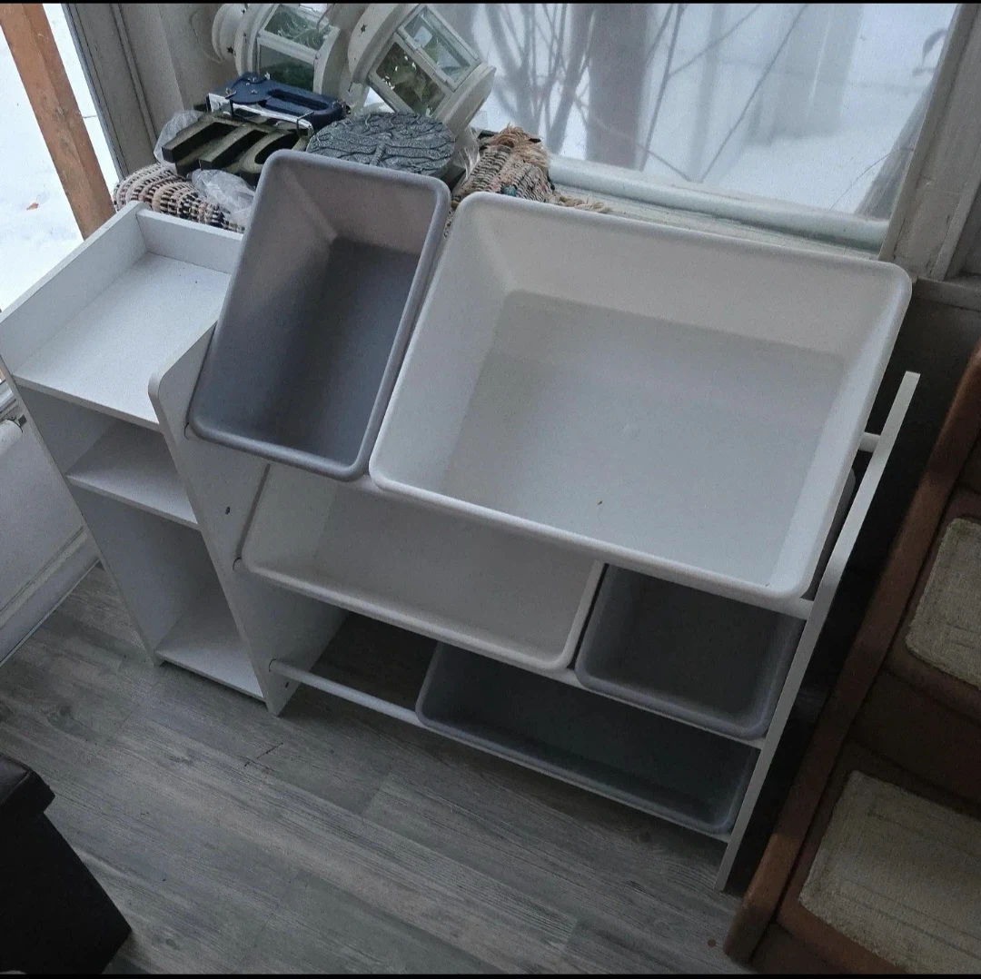 White toy storage shelf with bins