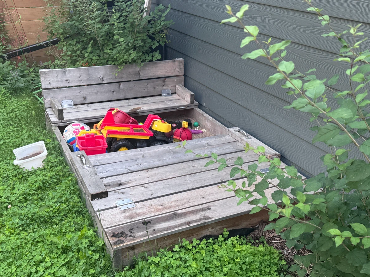 Wooden Sandbox and sand. Built-in Benches
