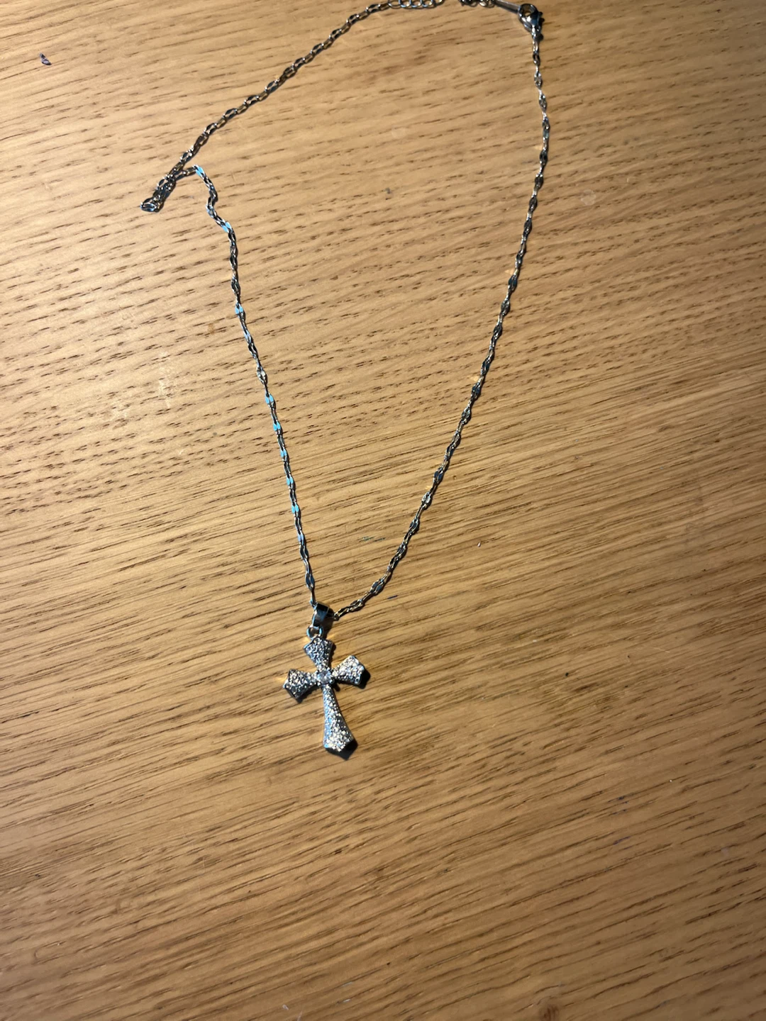 small curvy cross with gems