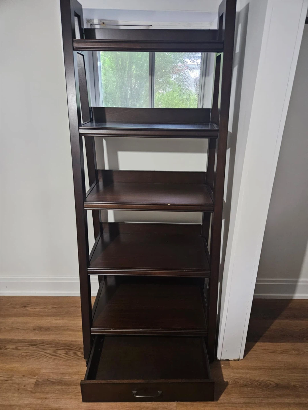 Dark brown shelving with drawer at the bottom