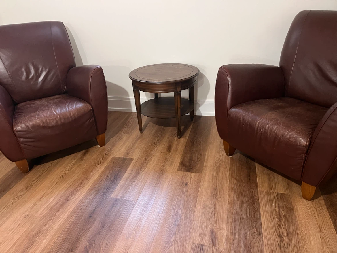 2 Brown Leather Armchairs with a side table