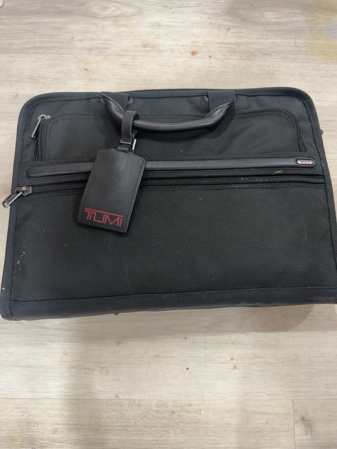 aTUMI black ballistic-nylon laptop/briefcase.