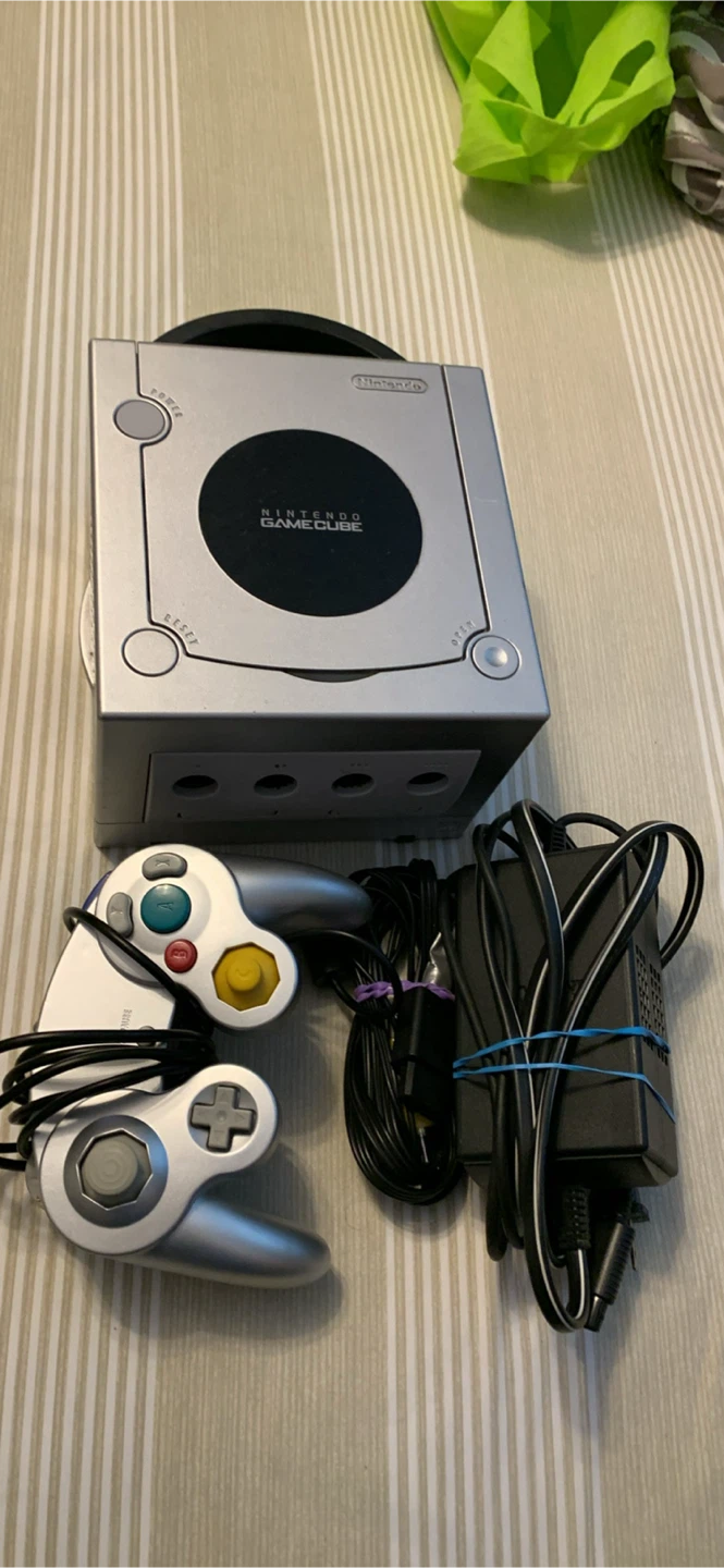 Silver nintendo gamecube with cords and controller