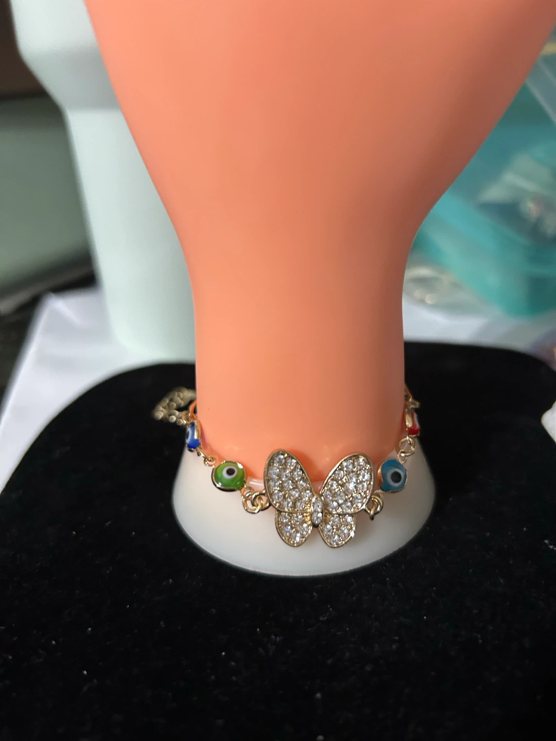 Gold tone butterfly evil eye charm bracelet
