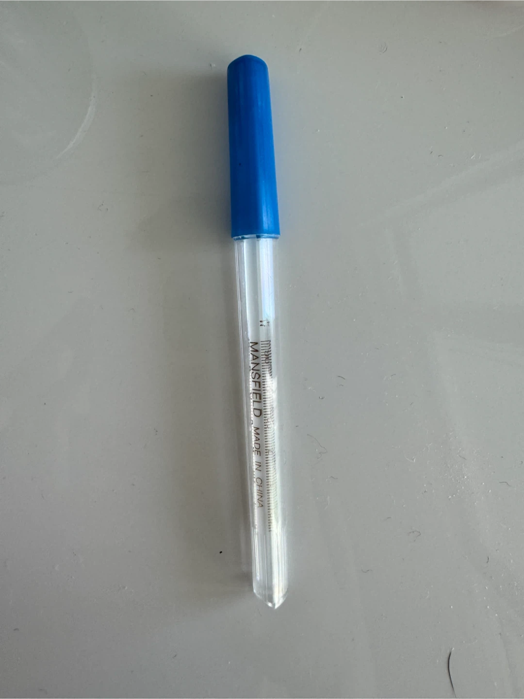 thermometer with storage cap