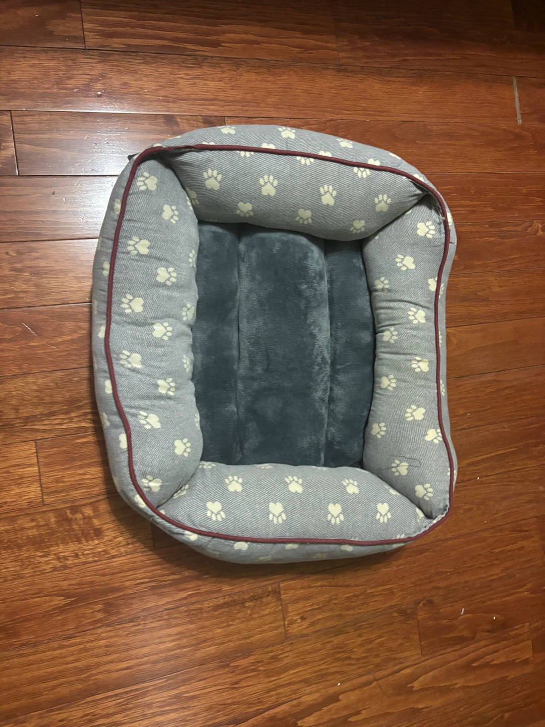 Grey dog bed with paw print pattern