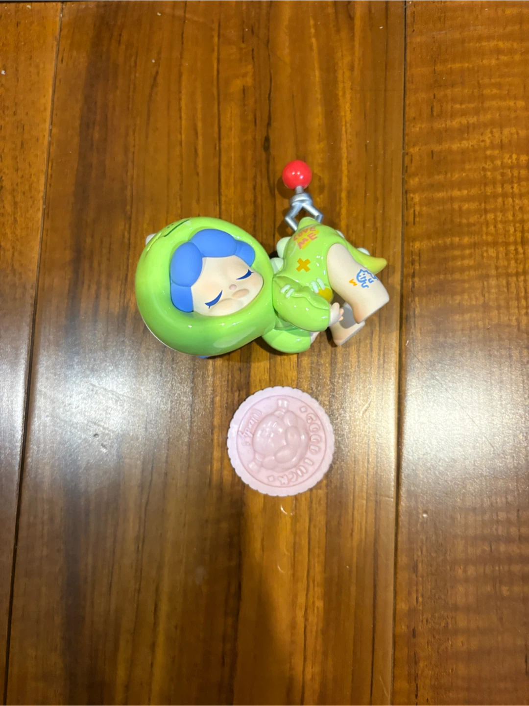 Green Character Figure with Pink Round Accessory