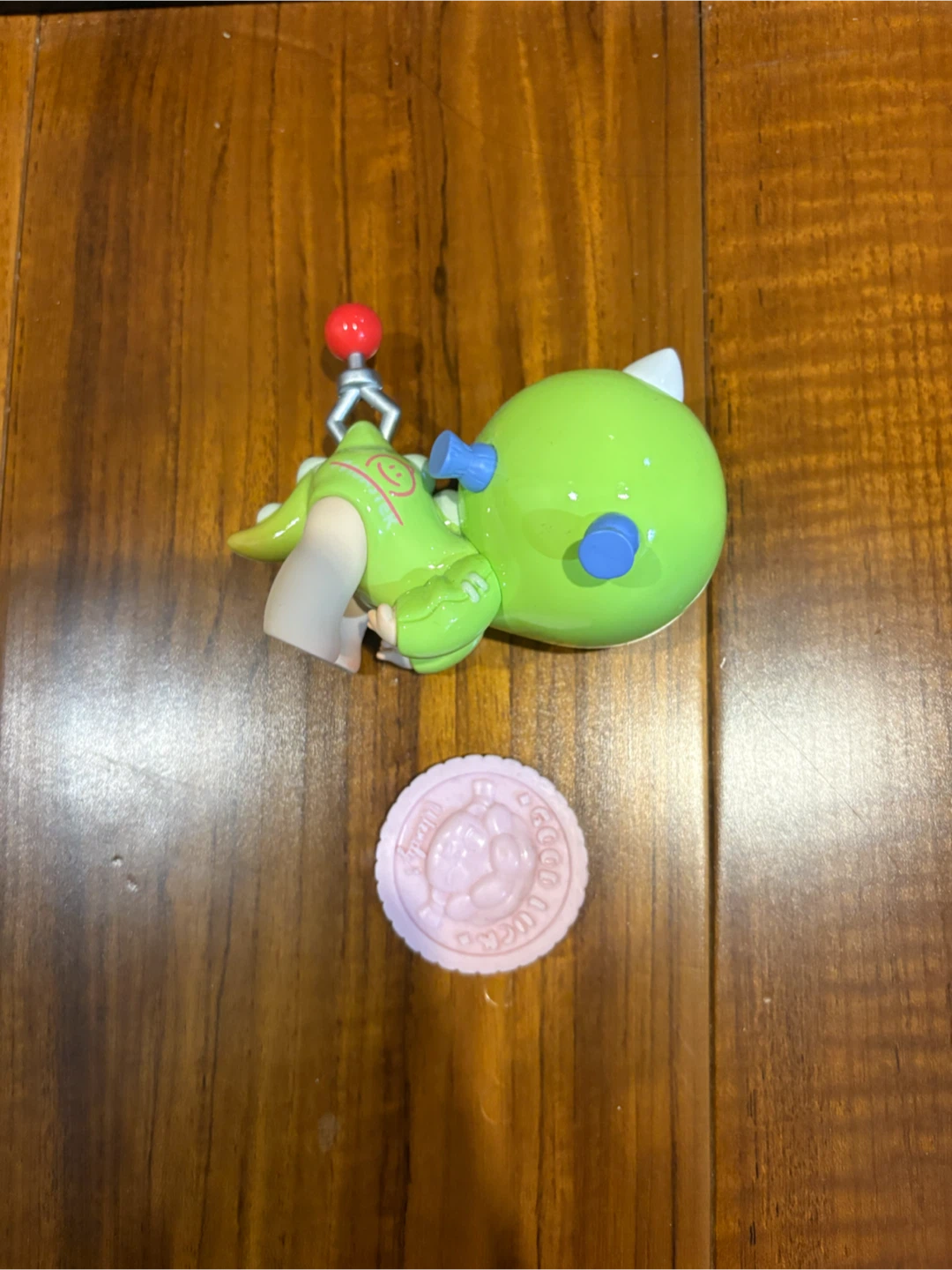 Green Character Figure with Pink Round Accessory - photo 2